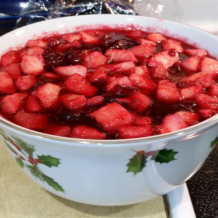 A bowl filled with fruit sitting on top of a counter