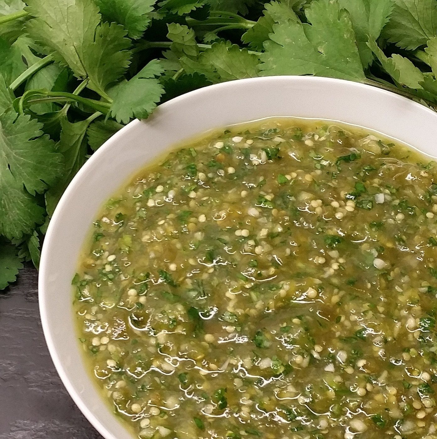 A bowl of freshly made Salsa Verde with a garnish of cilantro