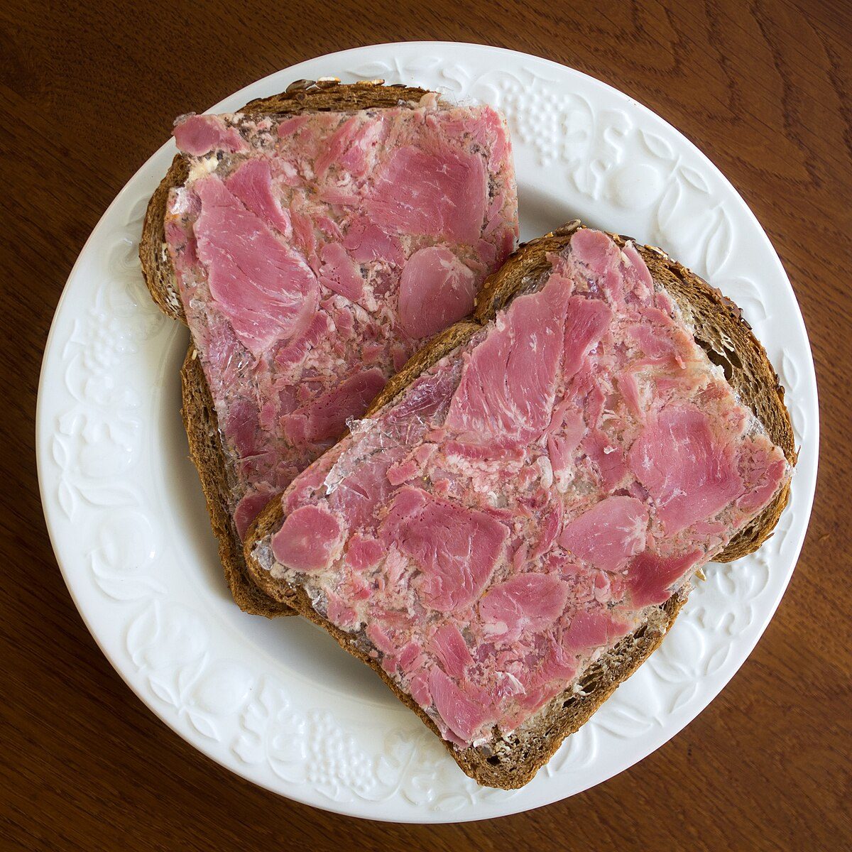 Plate of head cheese served with garnishments