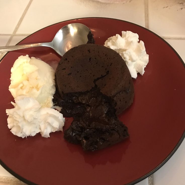 A red plate topped with ice cream and chocolate cookies