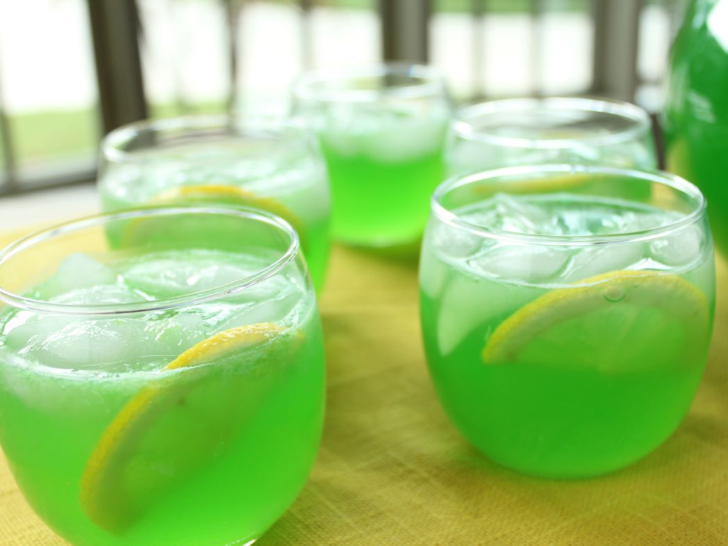 A delicious and vibrant Green Punch served in a bowl with colorful decorations.