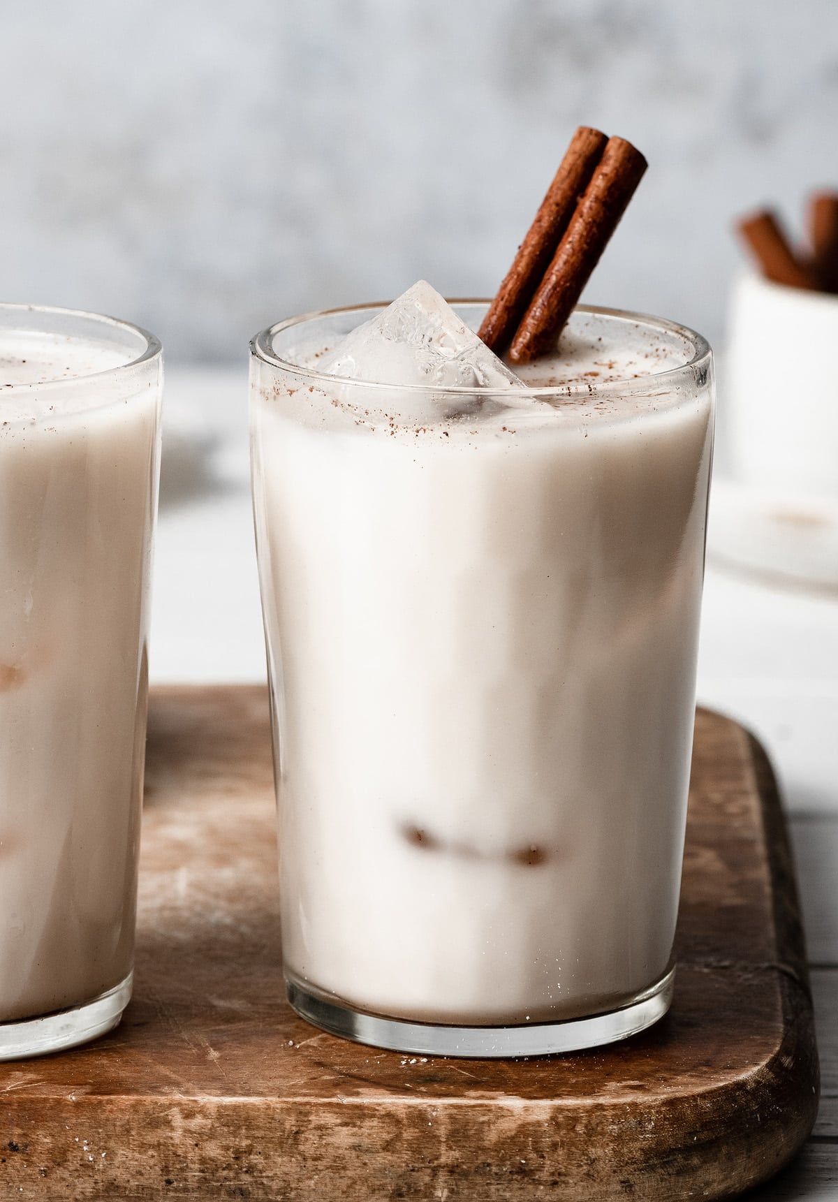 A glass of Horchata with cinnamon sticks