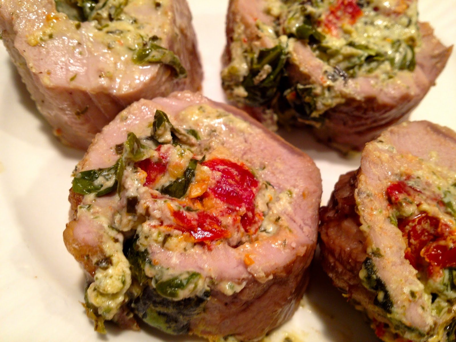Pork tenderloin stuffed with spinach, sun-dried tomatoes, and goat cheese