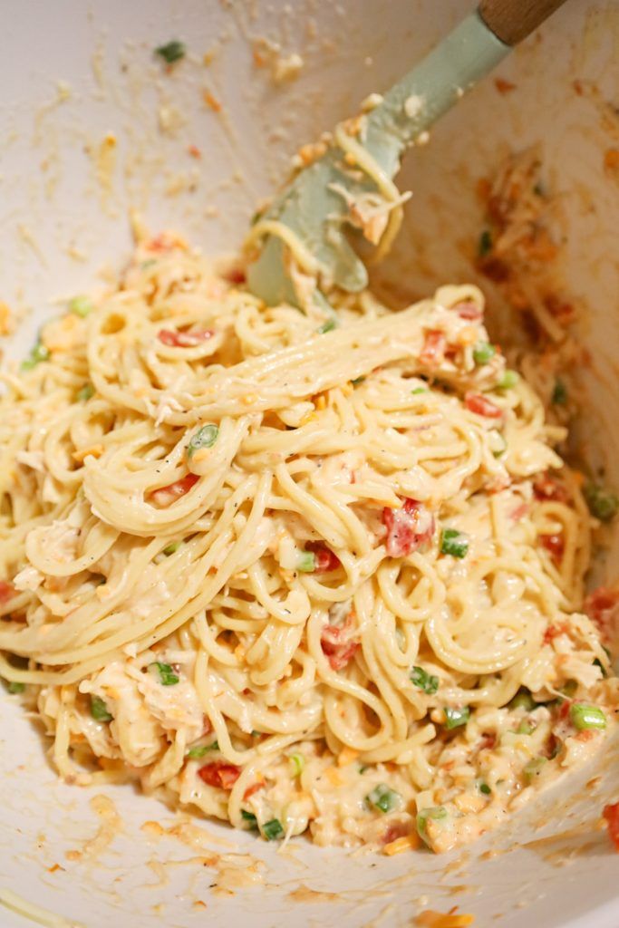 Chicken spaghetti with rotel in a mixing bowl