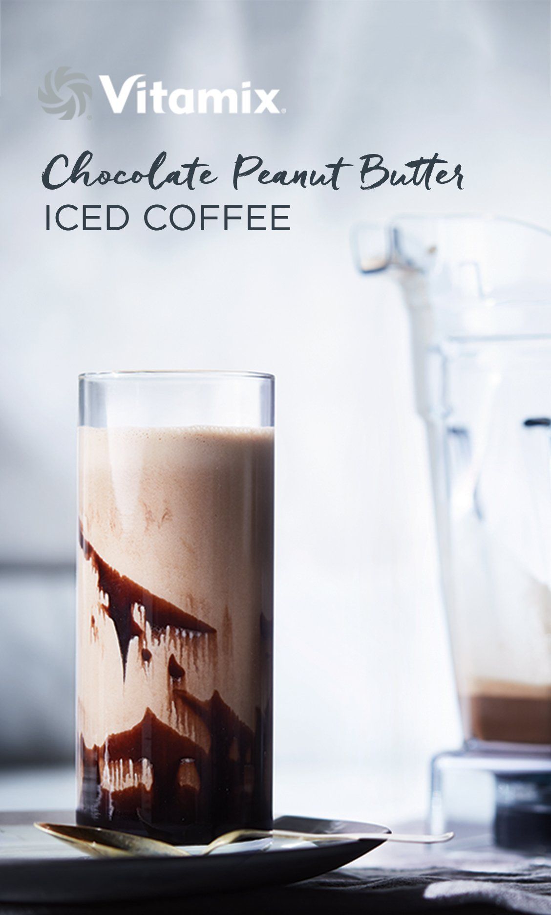 Chocolate Peanut Butter Iced Coffee in a glass with ice cubes and a straw