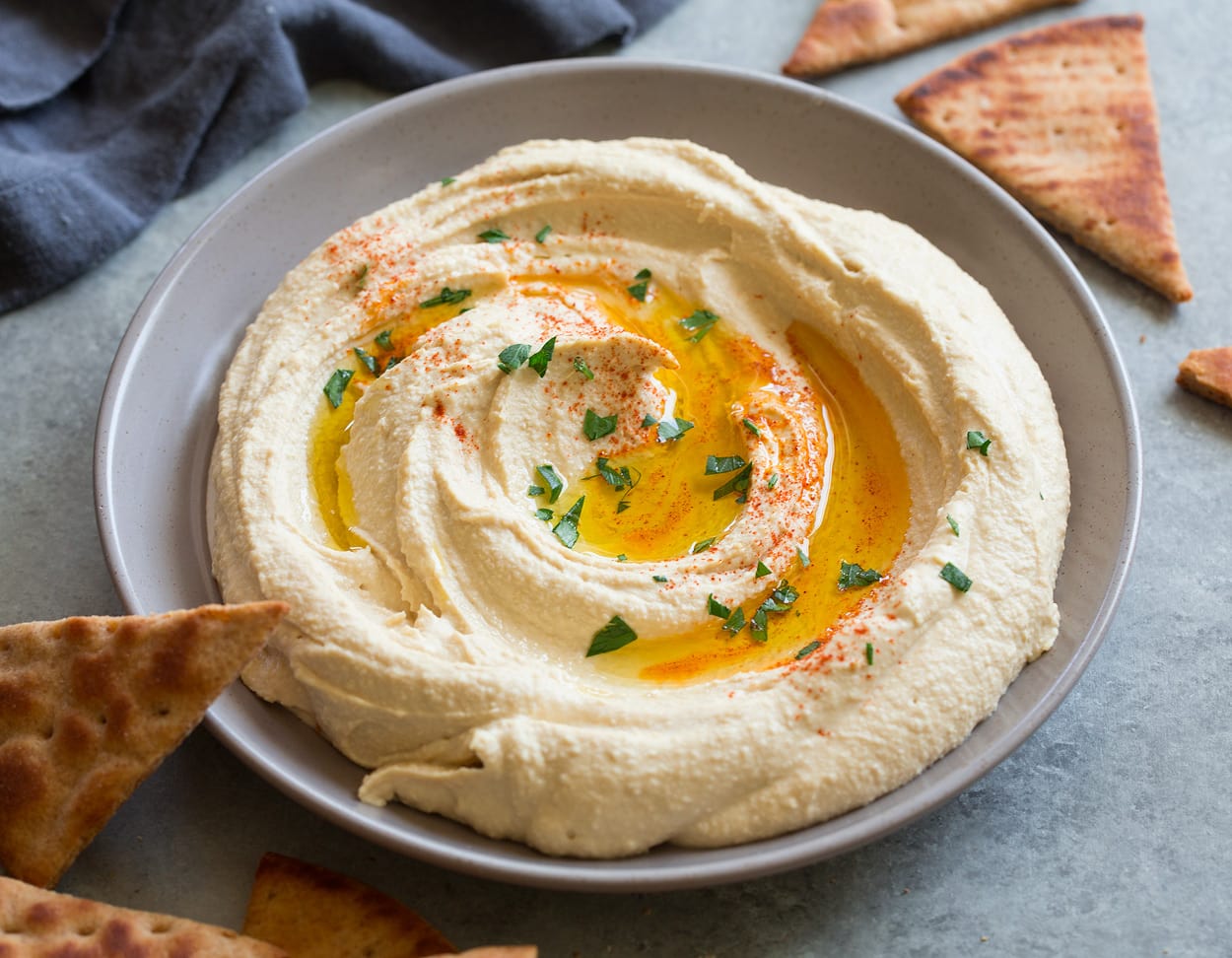 Delicious creamy hummus served with a drizzle of olive oil and garnished with paprika