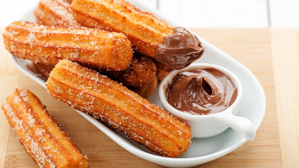 Churros served with chocolate sauce