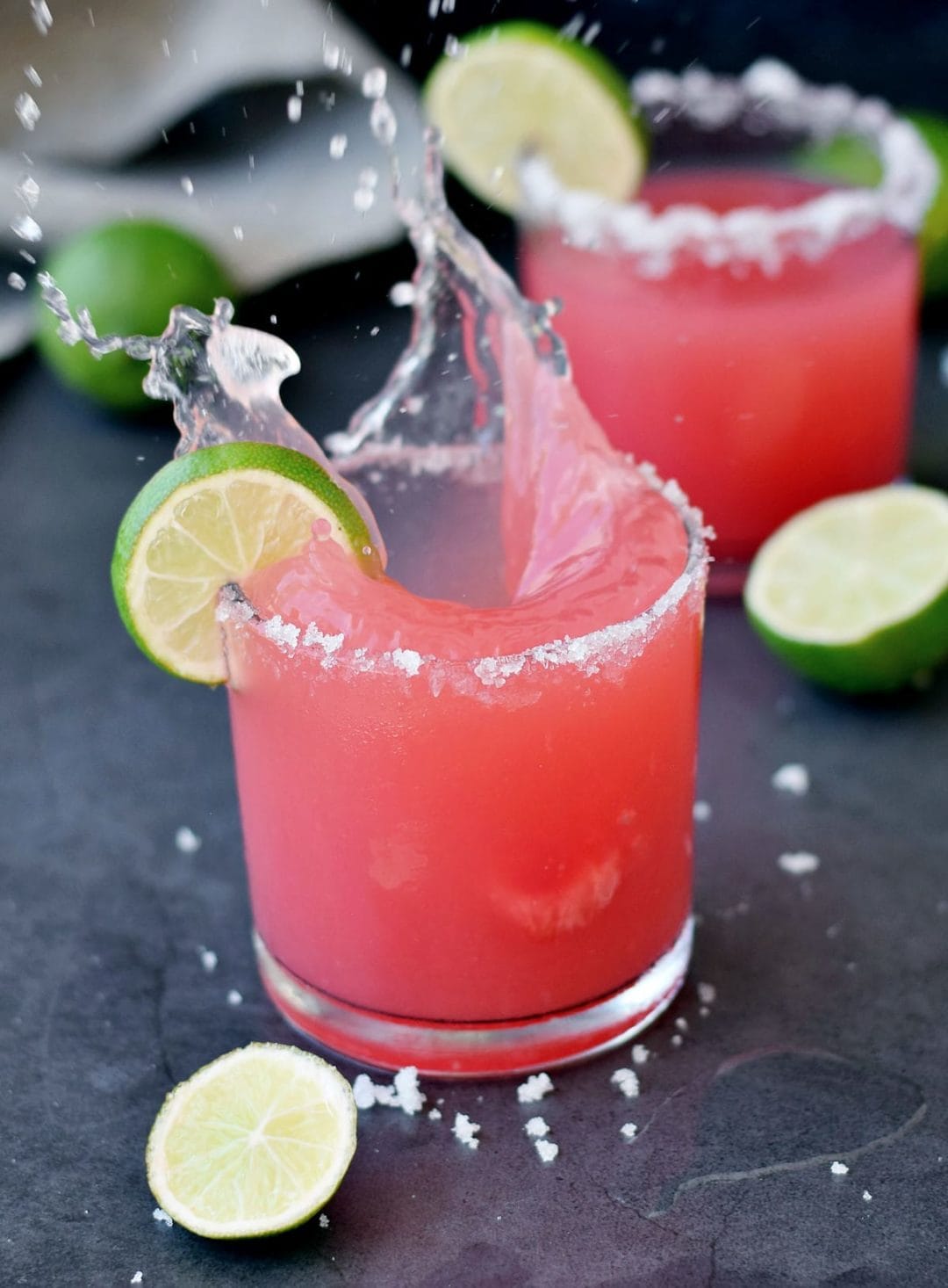 Watermelon Margarita with lime wedges
