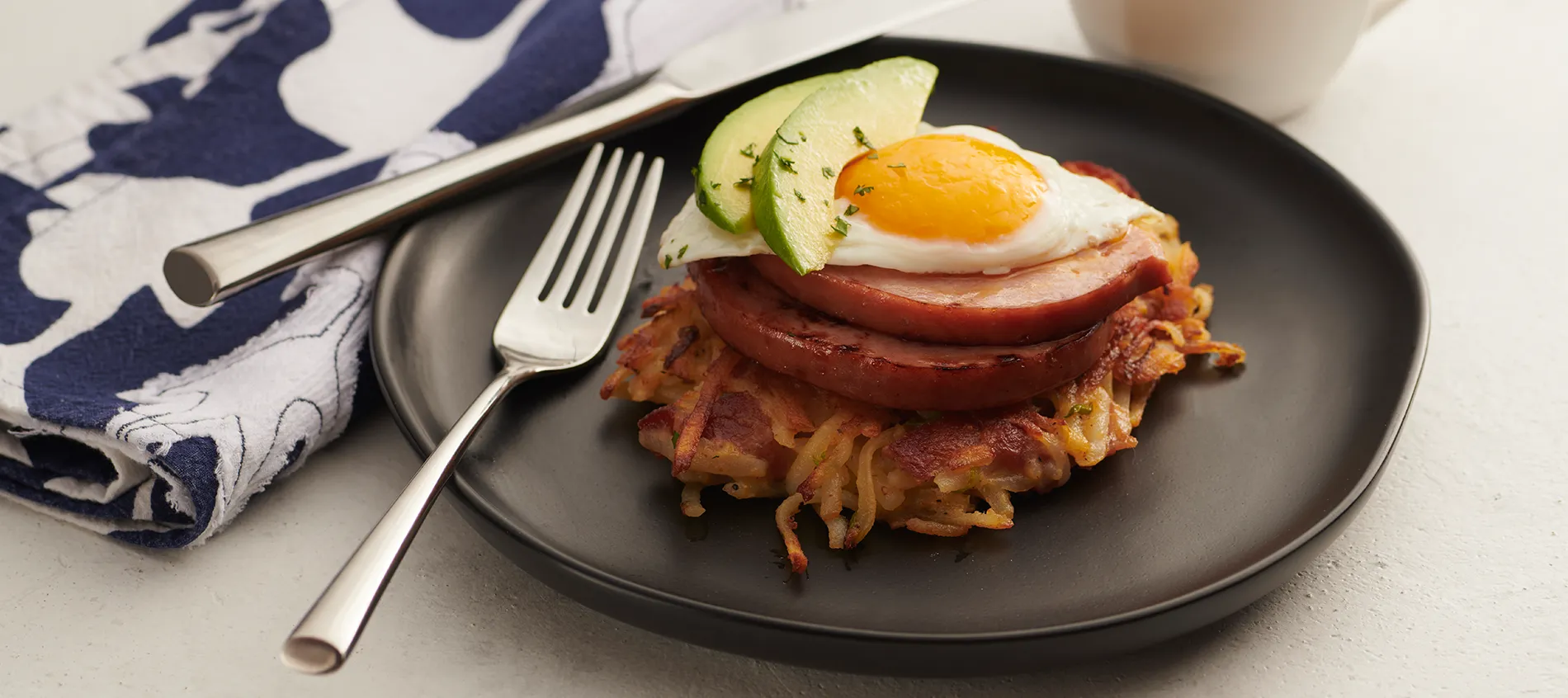 Bacon Potato Cakes with Ham Steak, Egg and Sliced Avocado