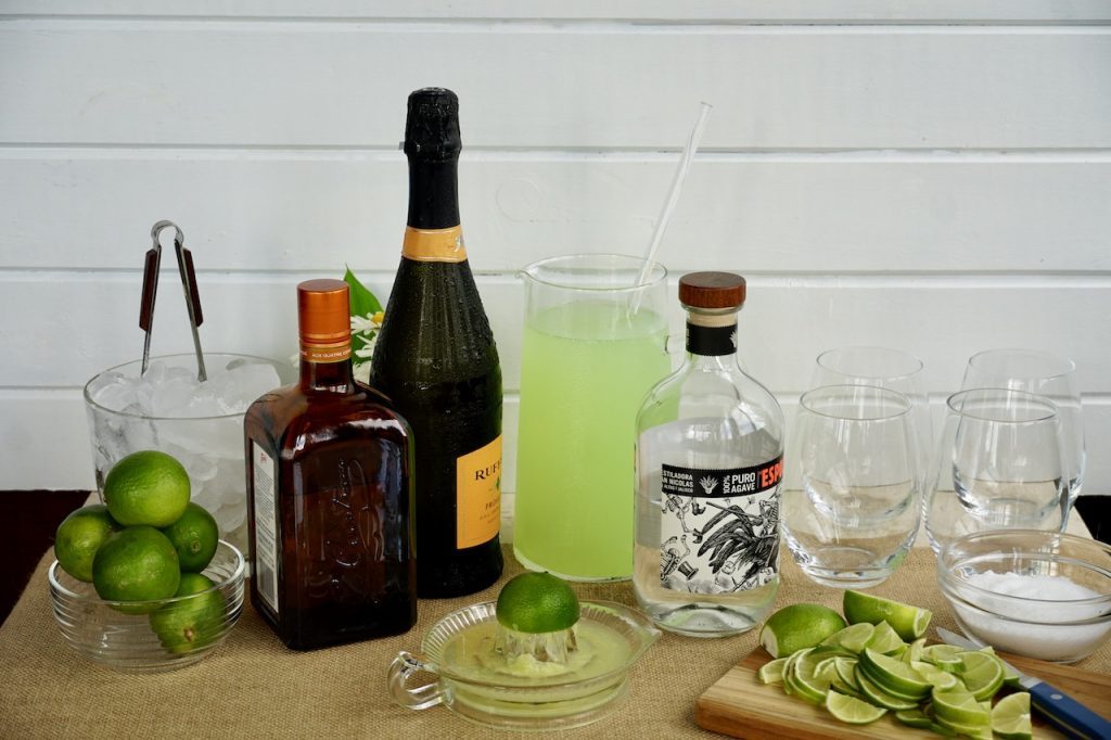 Margarita Fizz Punch in a glass with lime garnishes