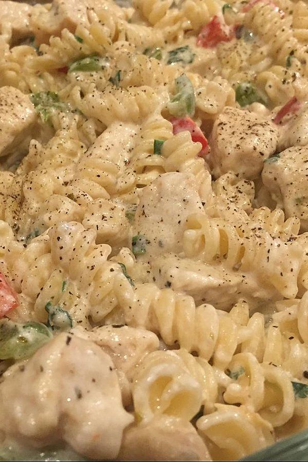 A bowl filled with pasta and meat covered in sauce