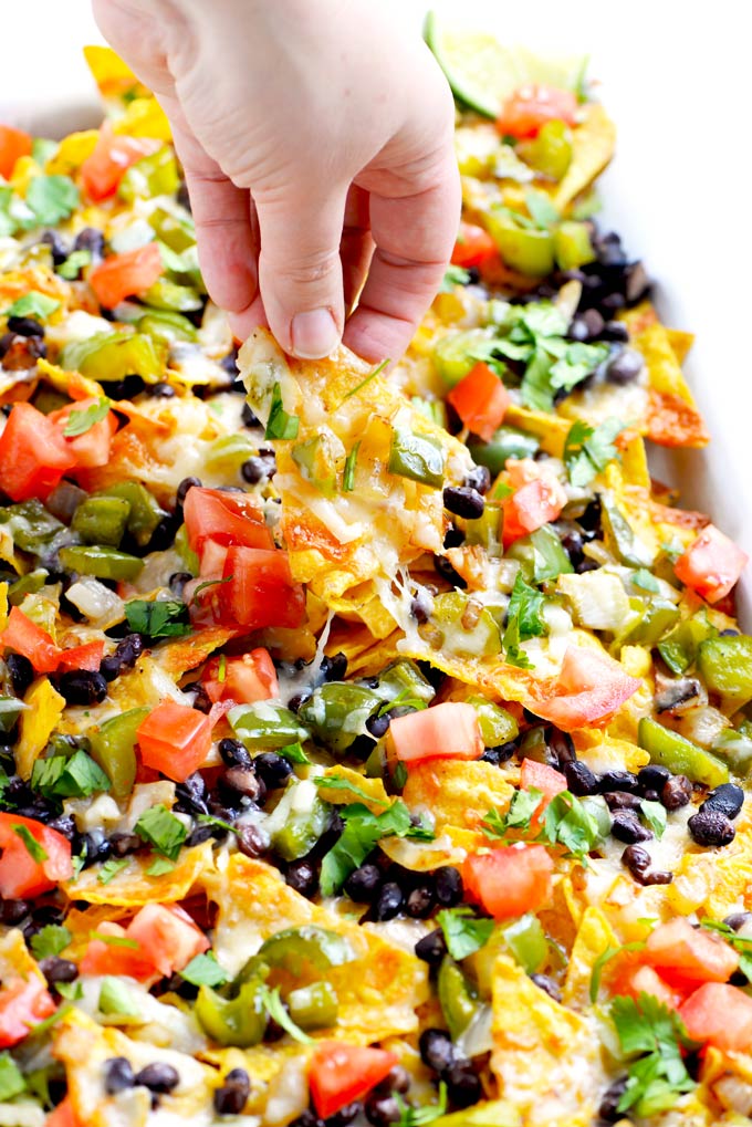 A plate of delicious vegetarian nachos topped with fresh ingredients