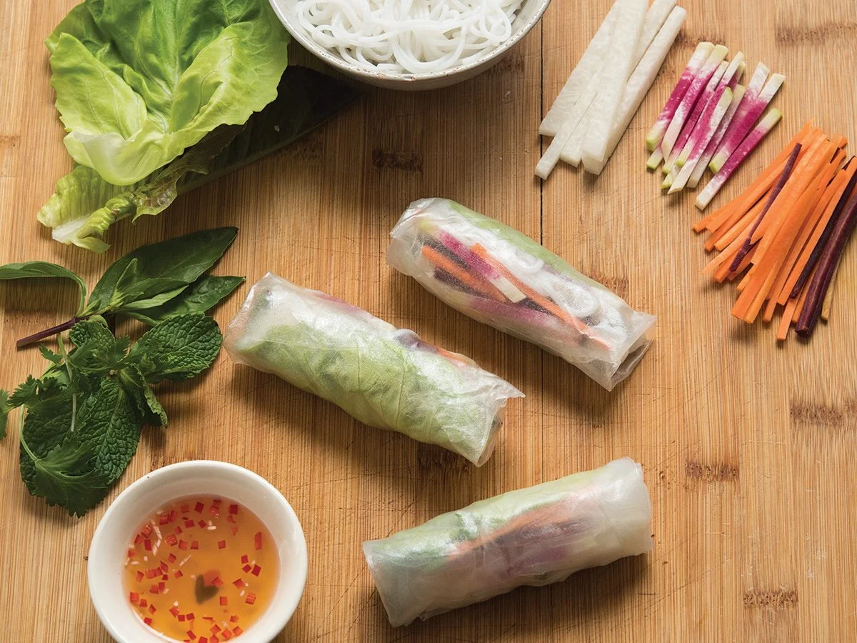 A platter of colorful Vietnamese salad rolls showcasing an array of fresh ingredients.