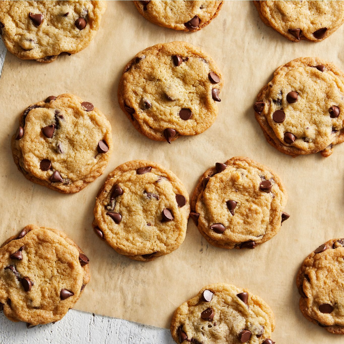 chocolate chip cookies arranged on top of parchment paper
