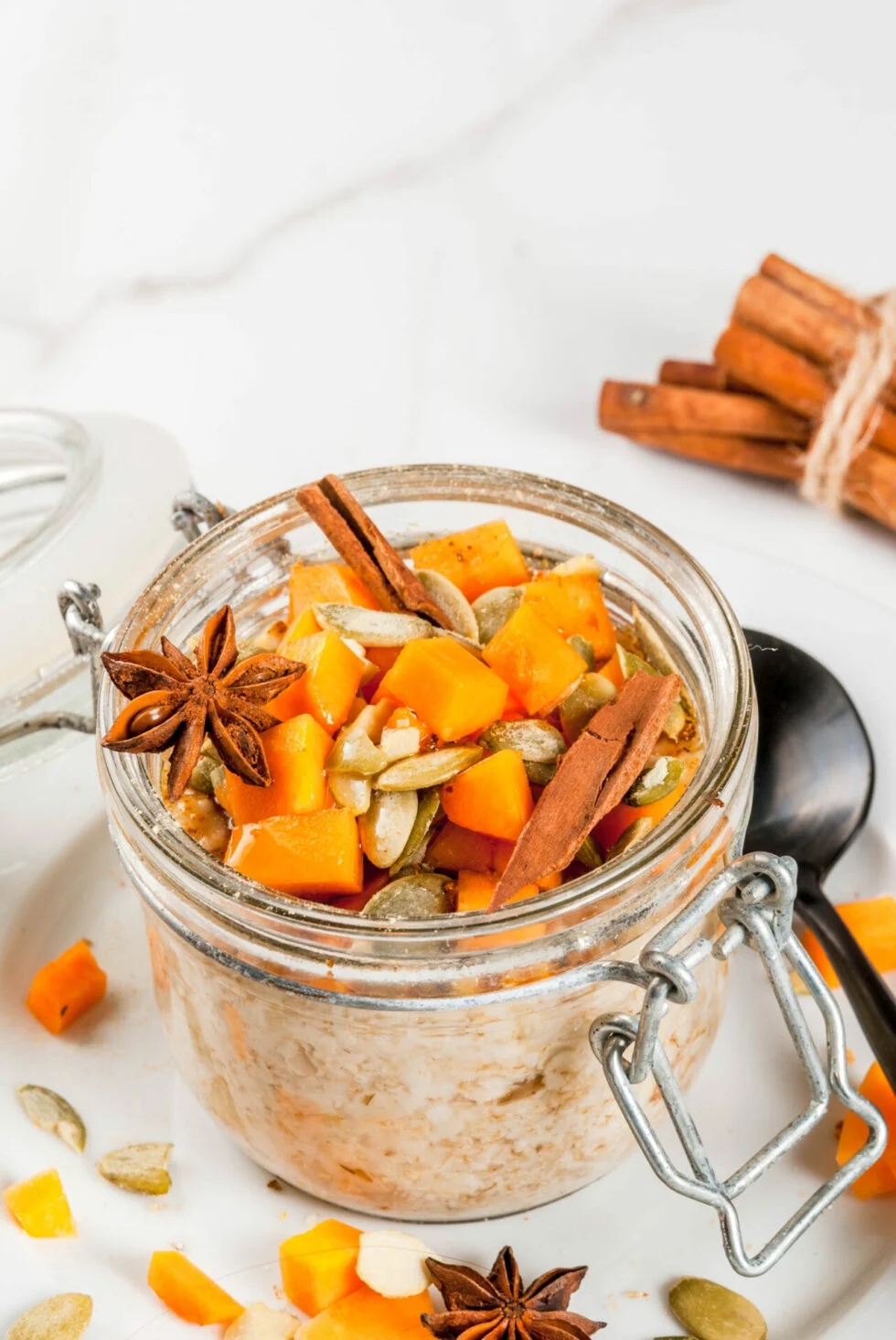 A bowl of Vegan Maple Pumpkin Overnight Oats topped with nuts and seeds